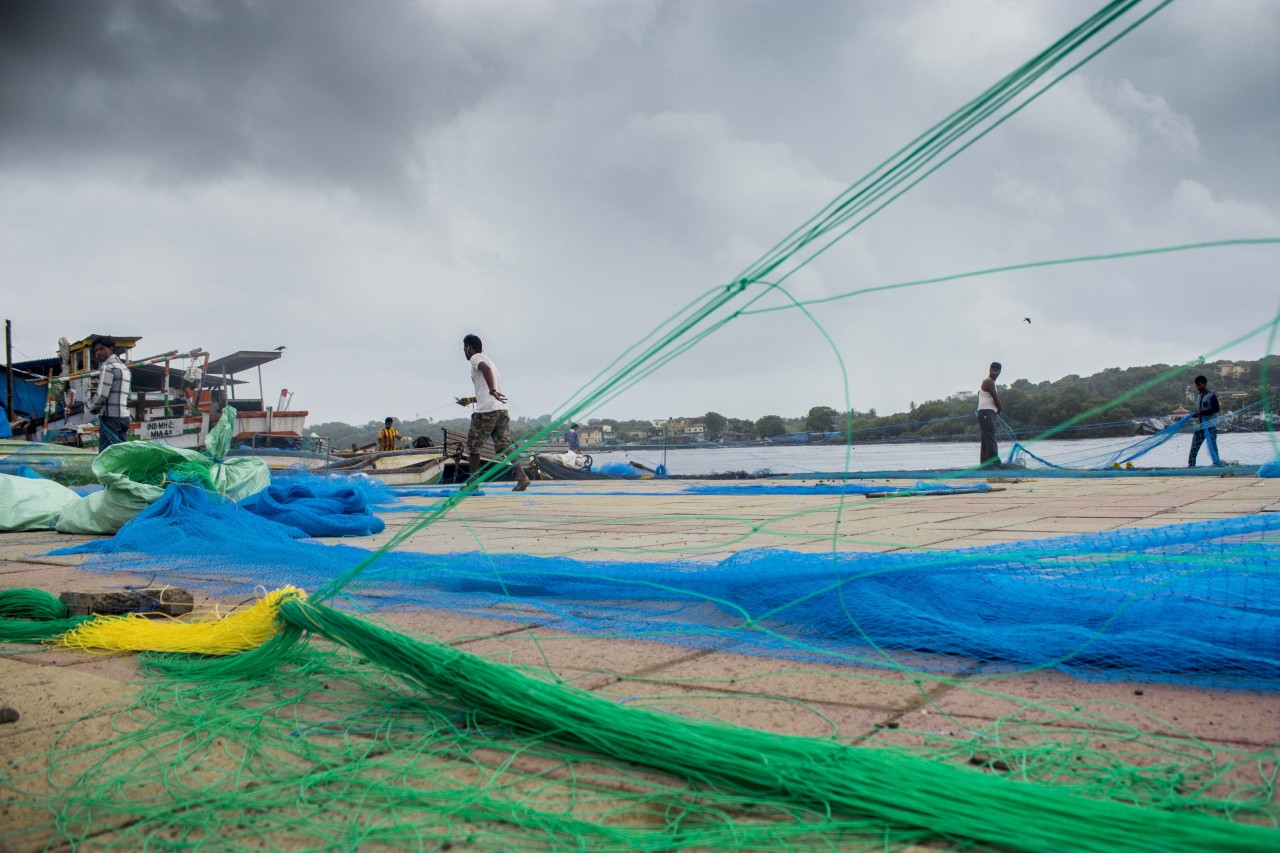 With the fishing season fast approaching, fishermen at Versova beach spend long hours working on vast nets in preparation.
#bombay