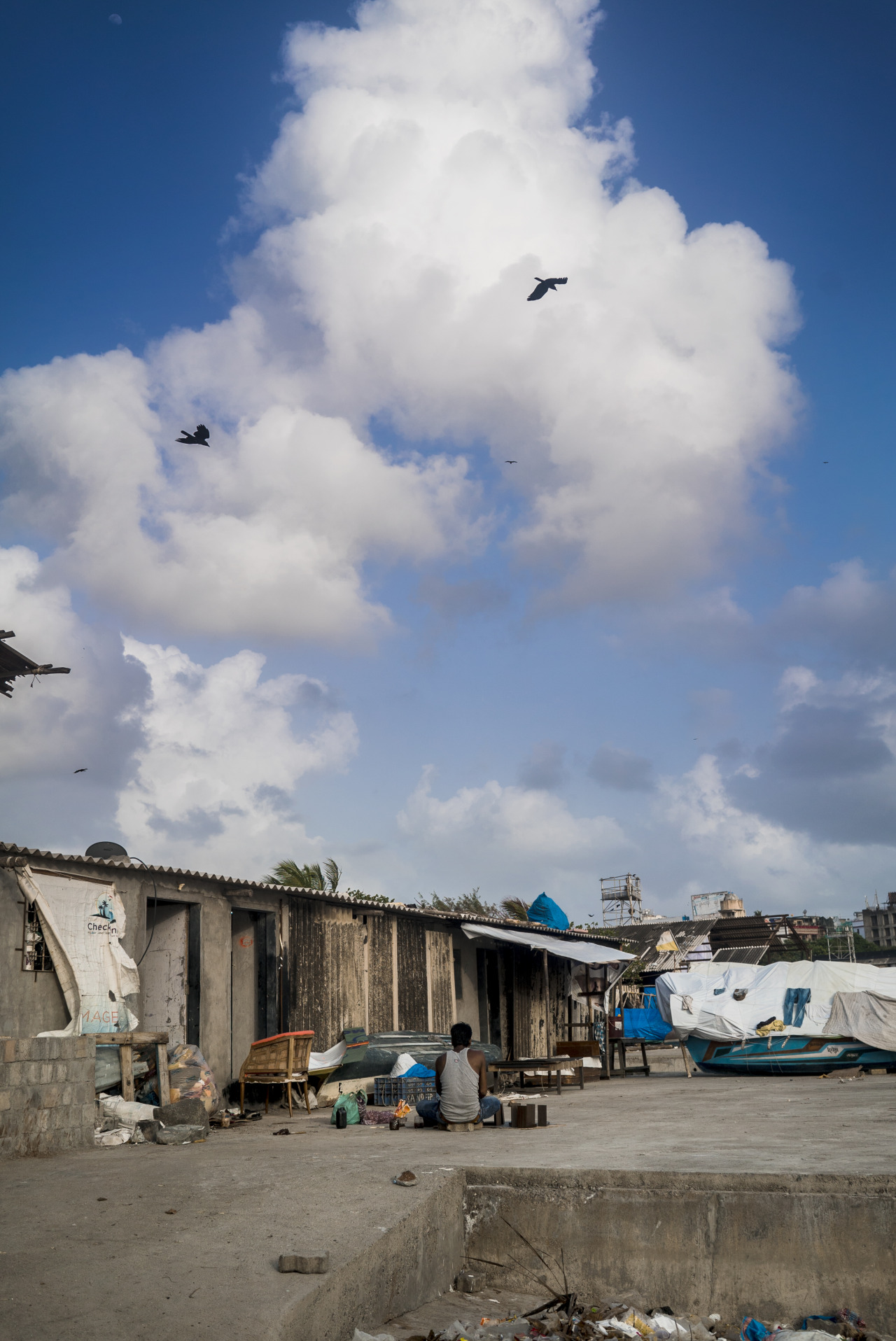 At Mahim Koliwada, a resident enjoys the sunshine and calm that precedes the monsoons.
Bombay / Mumbai, India.